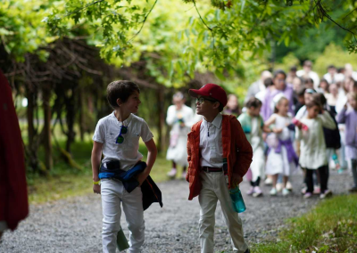 Two boys walk together, chatting, on the Shabbat Walk.